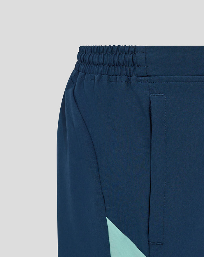 Back view of navy woven shorts showing an elastic waistband and stitched pocket seam.