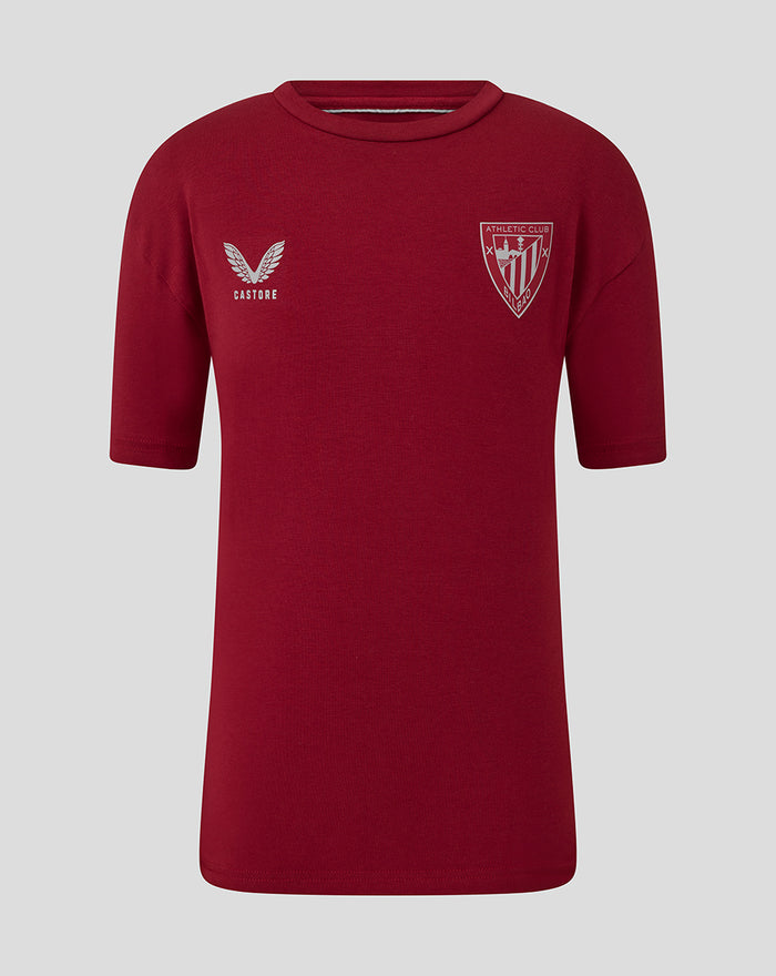 Junior red short sleeve Athletic Club travel tee with crest on chest and Castore logo.