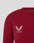 Close-up of red tee with winged Castore logo on the left chest