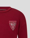 Close-up of red junior biking tee with athletic club crest on the chest