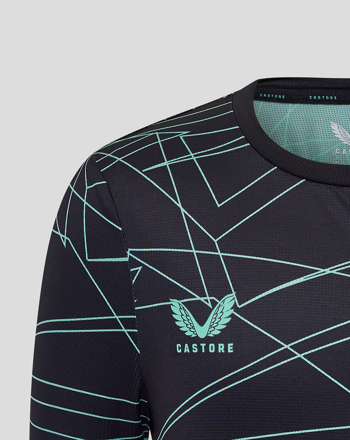 Close up of navy junior Athletic Club tee showing teal geometric pattern and crest on the chest