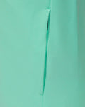 Close up of mint green jacket side panel with a vertical zipper and clean stitching details