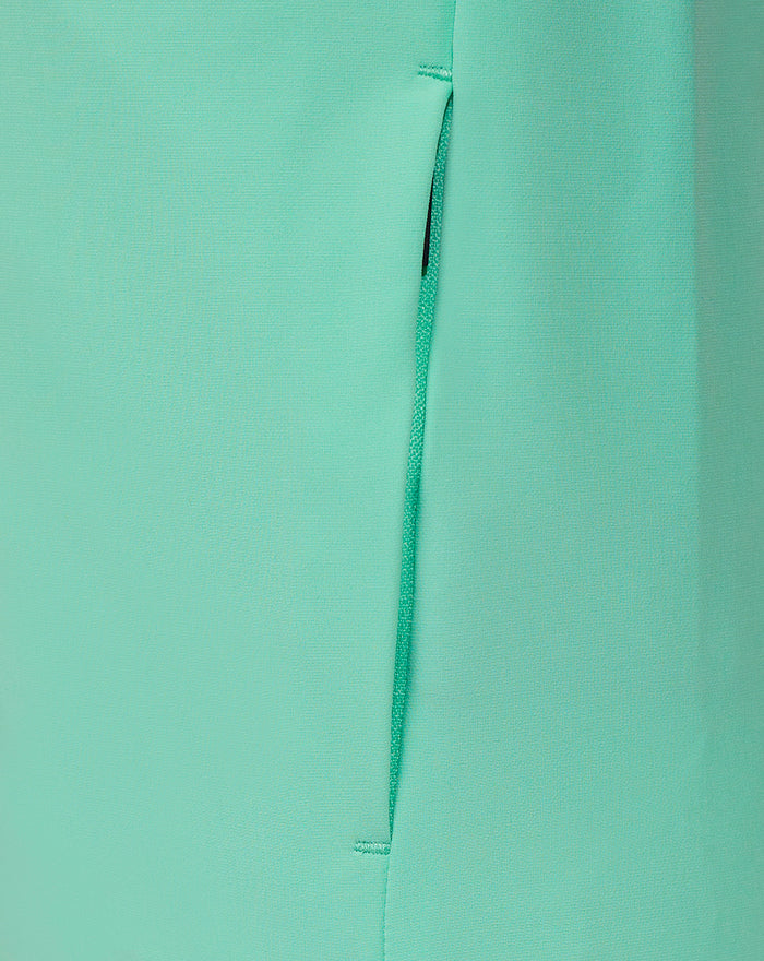 Close up of mint green jacket side panel with a vertical zipper and clean stitching details