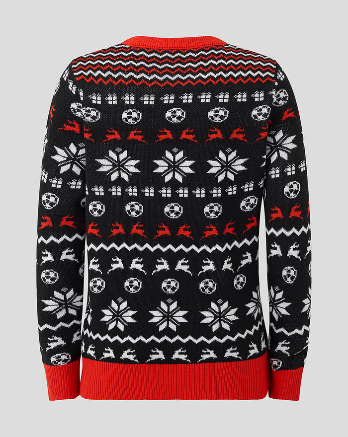 Back view of a black junior Athletic Club Christmas jumper with white snowflakes red reindeer motifs and red ribbed hem.