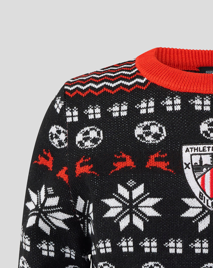 Close up of the chest area on the junior Athletic Club Christmas jumper with large white snowflakes and decorative pattern.