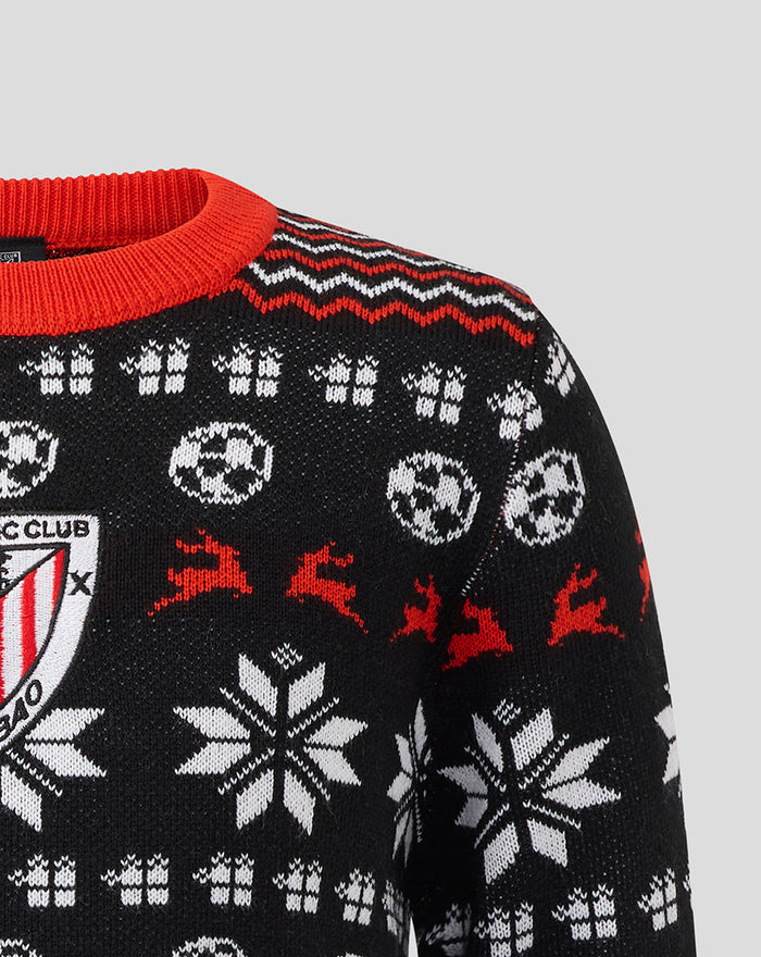 Close up of the black junior Athletic Club Christmas jumper showing a red knit collar and zigzag trim with crest on the chest.