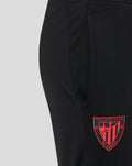 Close-up of black jog pants pocket with red Bilbao crest near the hem