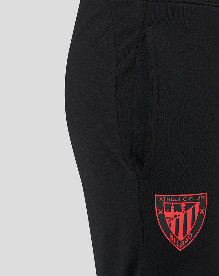Close-up of black jog pants pocket with red Bilbao crest near the hem