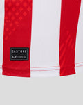 Close up of lower hem with Castore patch on the red and white striped jersey