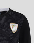 Close up of Athletic Club crest badge on black goalkeeper shirt with geometric print pattern