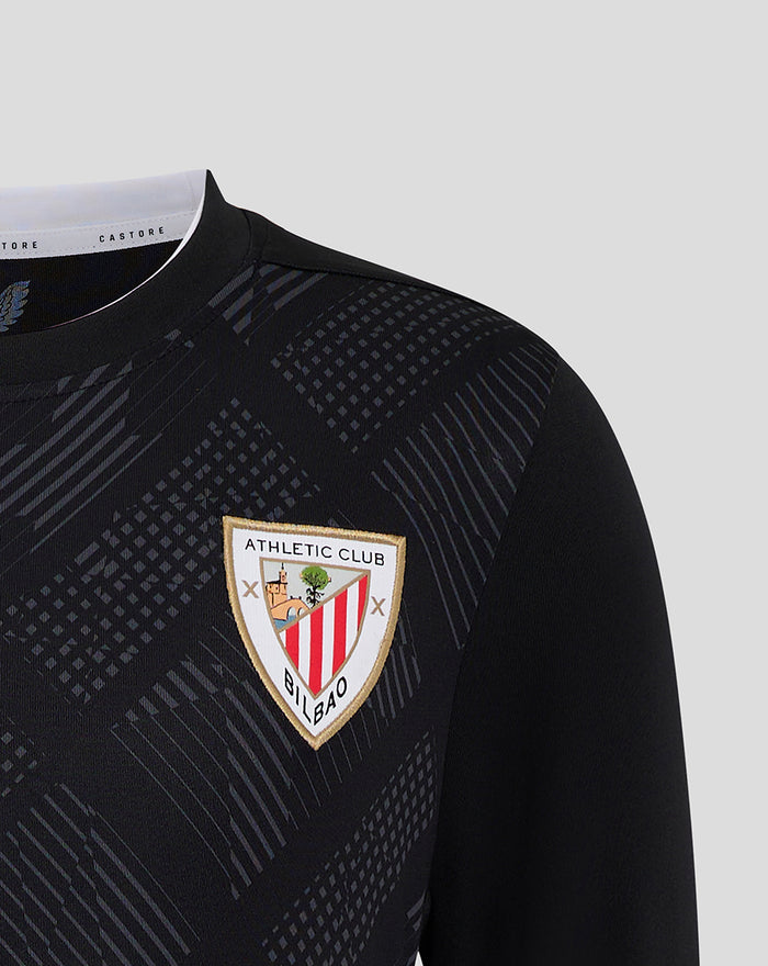 Close up of Athletic Club crest badge on black goalkeeper shirt with geometric print pattern