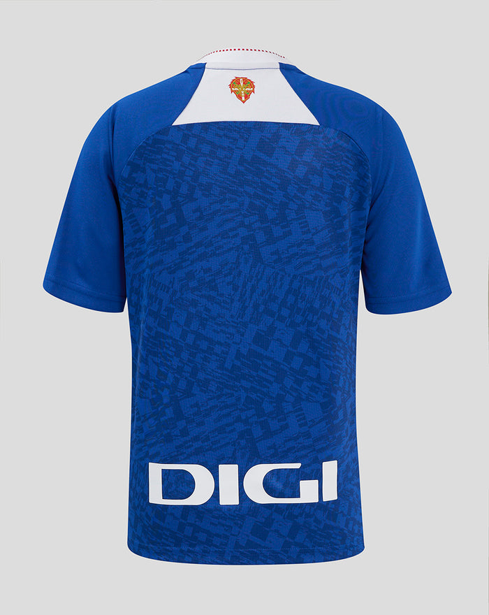 Close-up of left chest on blue away shirt showing Castore wing logo and Kutxabank sponsor across a jacquard pattern