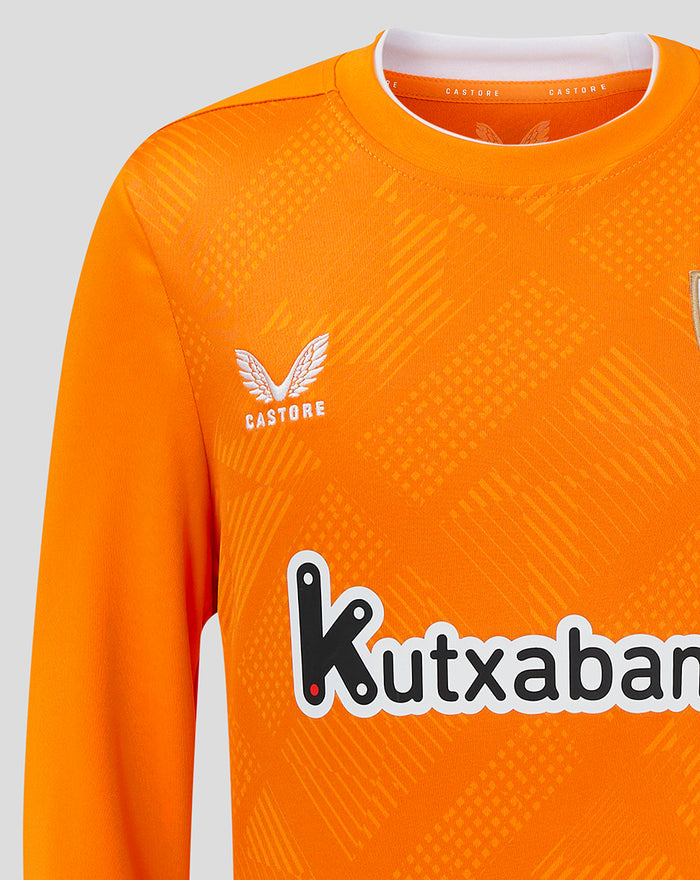 Shoulder close-up of orange goalkeeper shirt with textured pattern and partial crest visible