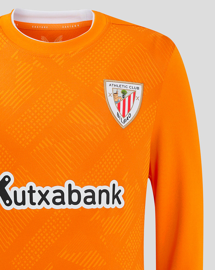 Front close-up of bright orange goalkeeper jersey showing crest on left chest and Kutxabank sponsor across the front