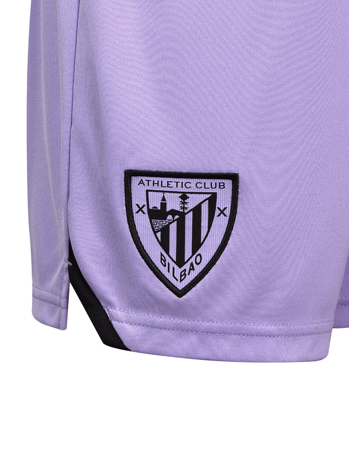 Close-up of the black embroidered Athletic Club Bilbao crest on lavender junior shorts.