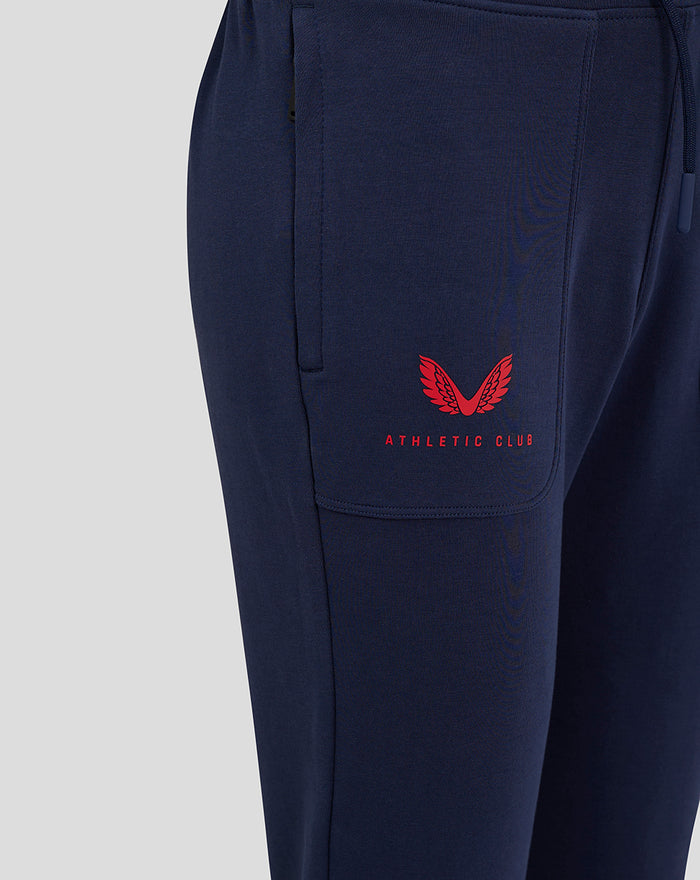 Navy junior travel pant with red Athletic Club logo on the thigh pocket area