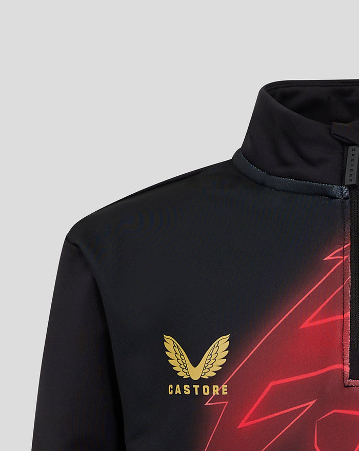 Close-up of the black MATCHDAY MIDLAYER 24/25 chest area showing gold Castore emblem and red geometric graphics.