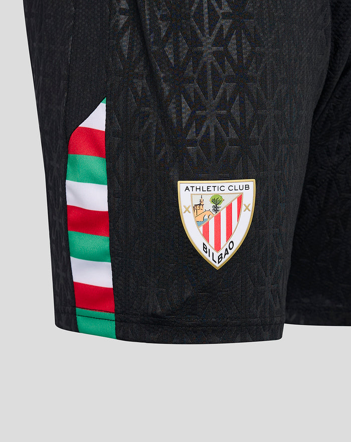 Close-up of black Pro Fourth shorts showing the geometric pattern with red white green side stripe and Bilbao crest on the leg