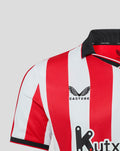 Close-up of upper front of red and white striped Athletic Club home shirt showing Castore logo and club crest.
