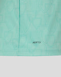 Close-up of mint green jersey fabric showing AerTek texture and a stitched hem with subtle embossed pattern.