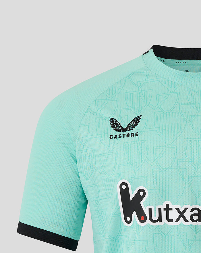 Close-up of turquoise Athletic Club shirt chest area showing crest, Castore logo, and Kutxabank sponsor across the front.