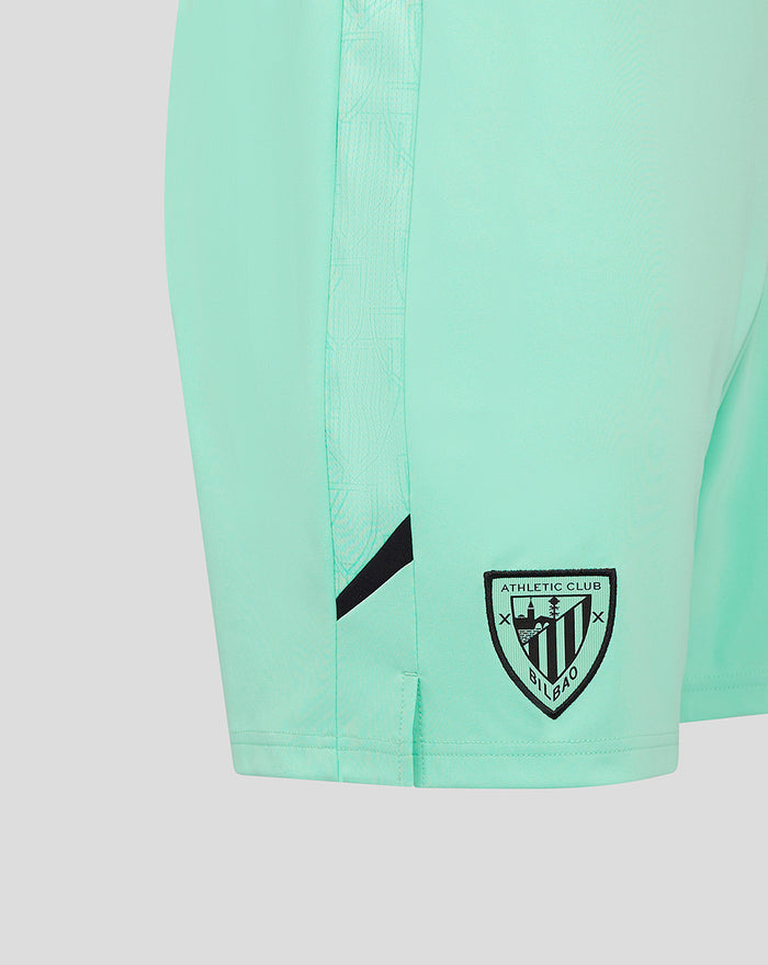 Close-up of mint green Athletic Club Third Shorts showing side panel detail and crest patch at the hem