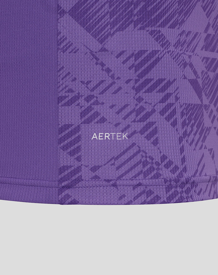 Close up of purple AerTek fabric with geometric pattern and hem stitching on the goalkeeper jersey