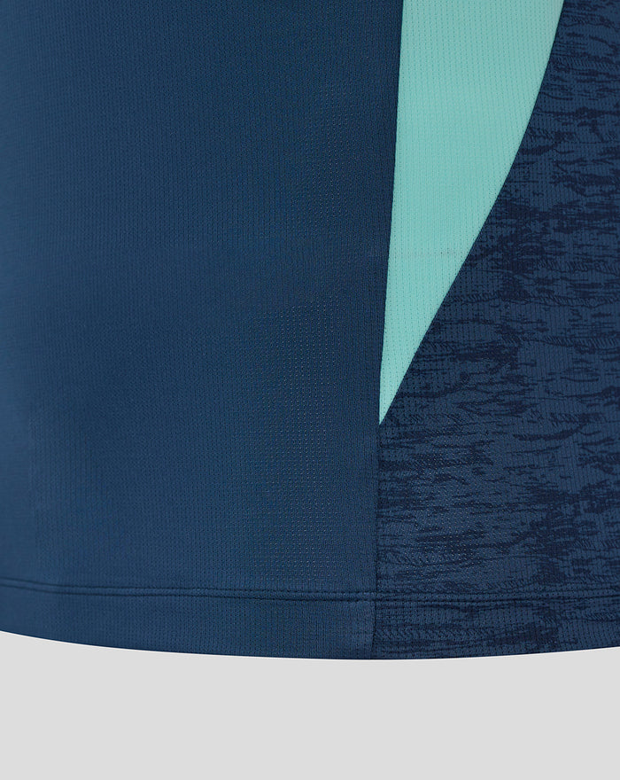 Lower front of navy athletic club tee showing teal side panel and textured sleeve detail.