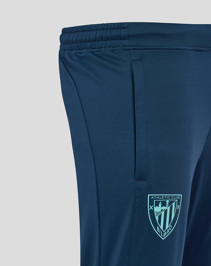 Side view of navy Athletic Club knit pants with crest on thigh and teal color panels