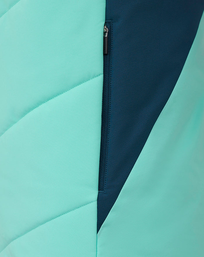 Close-up of mint green and dark teal color blocked athletic club performance gilet with a vertical zipper.