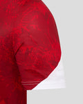 Red jersey sleeve with white cuff and visible stitching on a grey background