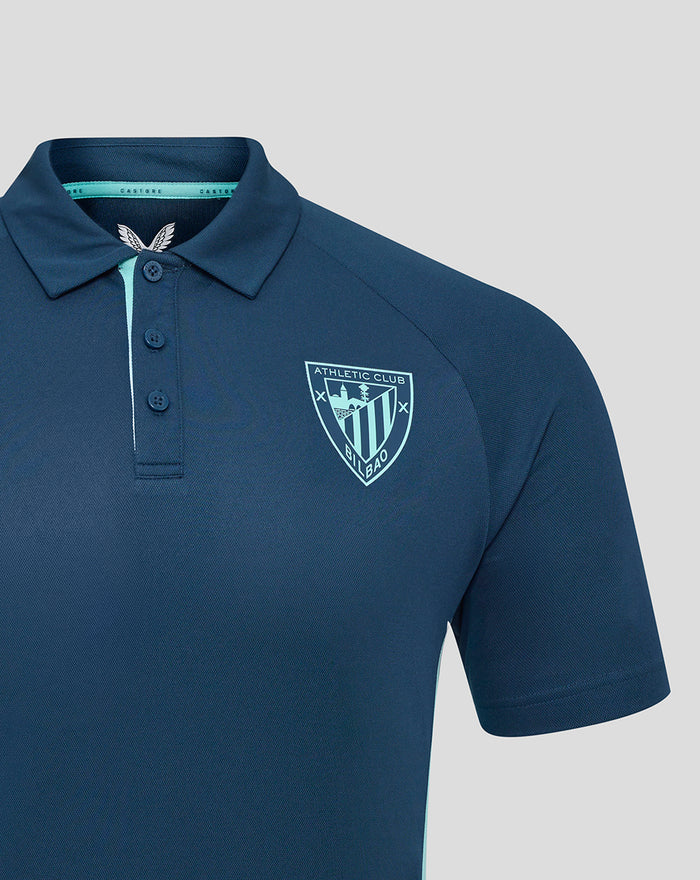 Close up of navy blue Athletic Club poly polo with crest on left chest and teal placket trim