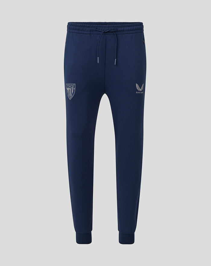 Navy travel knit pant with drawstring waist and tapered cuffs featuring crest on the left thigh and Castore logo on the right