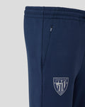 Navy Athletic Club travel knit pant shown in side view with a zip pocket and club crest on the lower leg