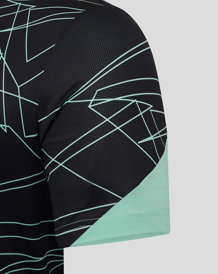 Sleeve close up of the Athletic Club tee showing mint geometric pattern and mint cuff.
