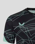 Close-up of upper chest on black tee with mint geometric lines and club crest on front