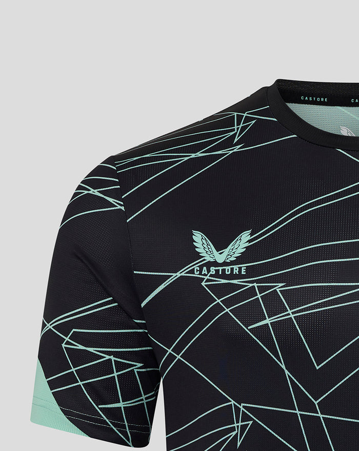 Close-up of upper chest on black tee with mint geometric lines and club crest on front