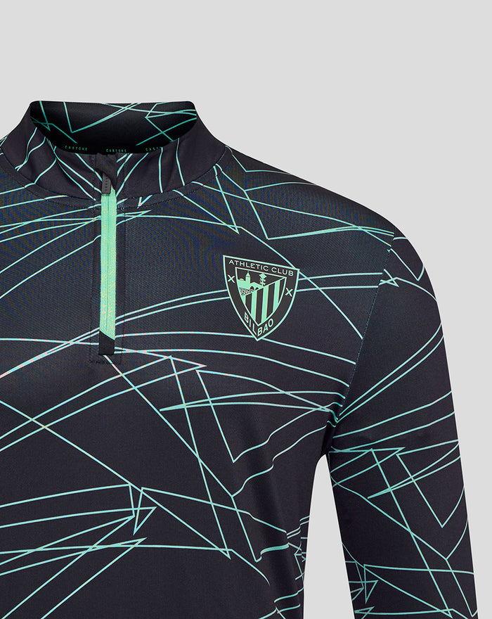 Chest and shoulder view of Athletic Club 3rd pre match midlayer top with teal geometric pattern and crest badge
