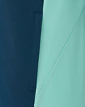 Close up of navy and mint fabric panels on the jacket showing a diagonal seam