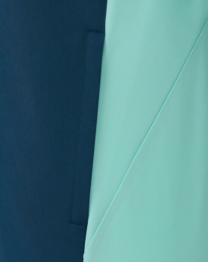 Close up of navy and mint fabric panels on the jacket showing a diagonal seam