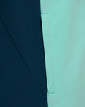 Detail shot of Athletic Club presentation hooded jacket fabric in navy and mint green with a vertical seam.