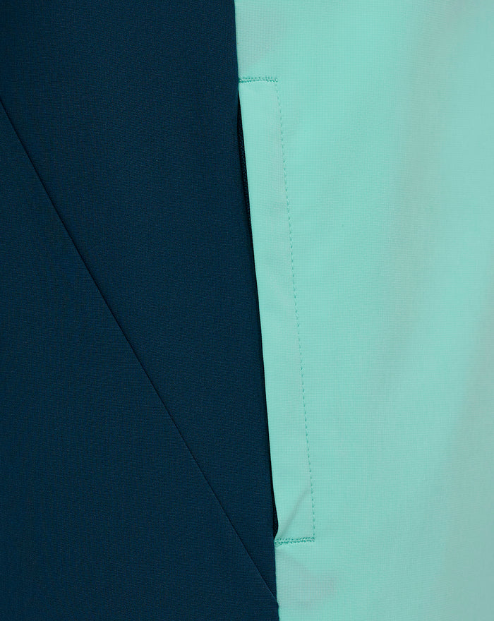 Detail shot of Athletic Club presentation hooded jacket fabric in navy and mint green with a vertical seam.