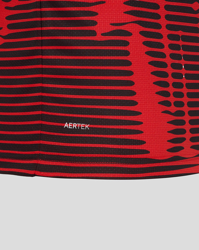 Close up of red and black striped fabric from Athletic Club 4th junior shirt with AERTEK branding near the hem.