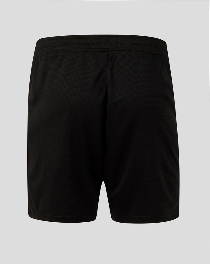 Back view of black shorts showing a red crest patch on the left leg near the hem.