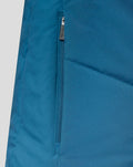 Zipper pocket detail on teal training jacket with fabric tag trim