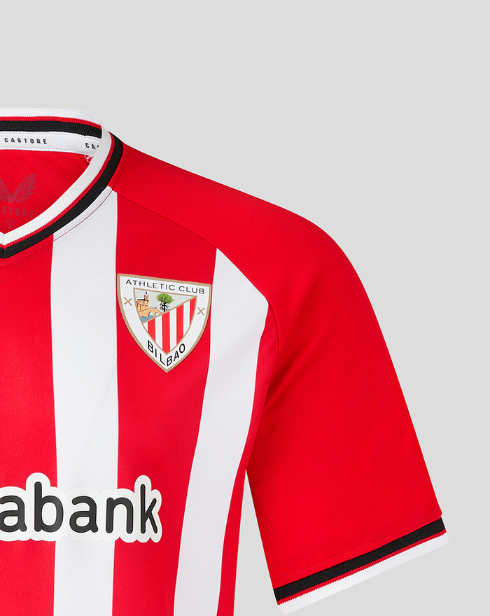 Left chest crest visible on red and white striped jersey with large sponsor text along lower front