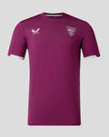 Kids burgundy travel jersey polo with club crest on left chest and Castore logo on right