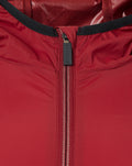 Close-up of red wind runner jacket zipper with black collar trim