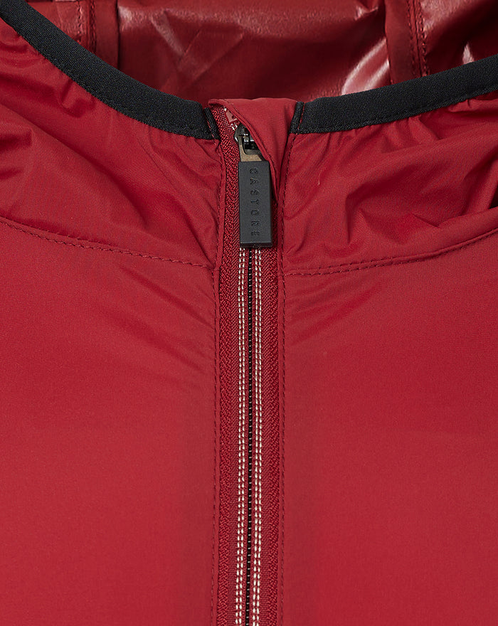 Close-up of red wind runner jacket zipper with black collar trim