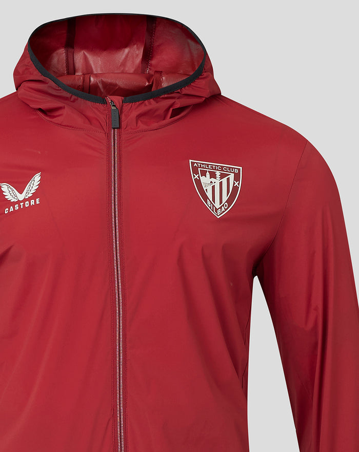 Front close up of red windrunner jacket with hood, Castore logo and Athletic Club Bilbao crest